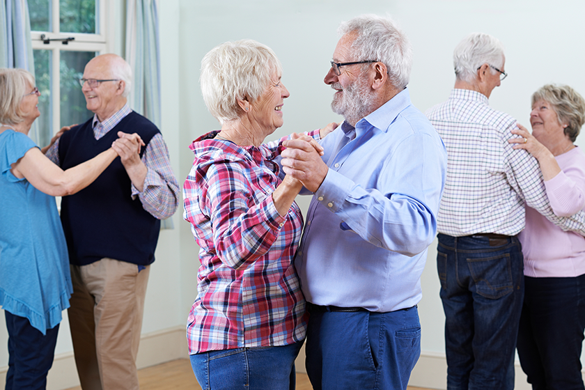 Group Of Seniors Enjoying Dancing Club Together