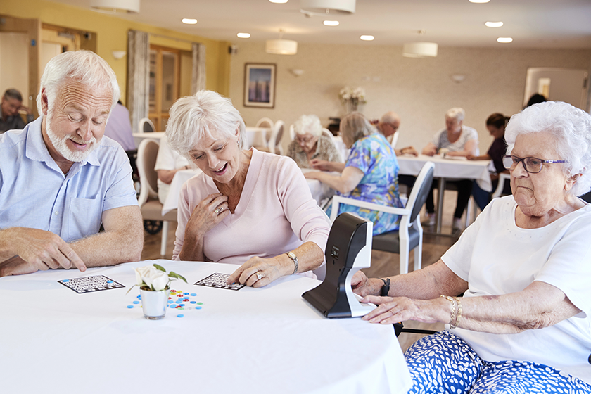 Group Of Seniors Playing Game Of Bingo