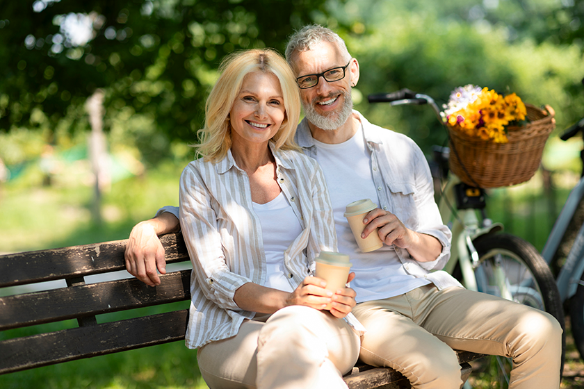 Happy Mature Couple With Takeaway Coffee