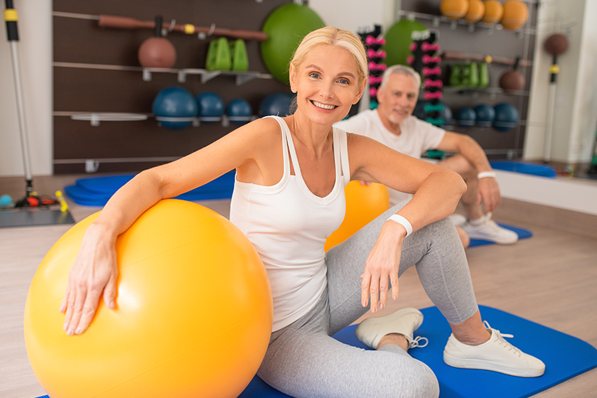 Middle-aged couple spending time in gym