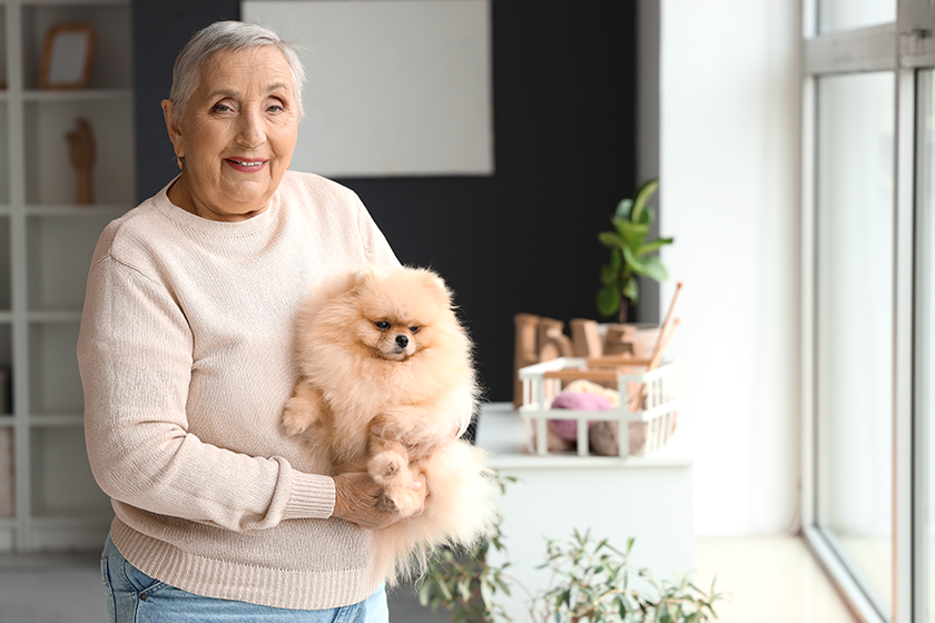 Senior woman with Pomeranian dog